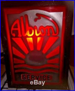 Vintage illuminated Albion motoring service sign with sun, sea and snake motif
